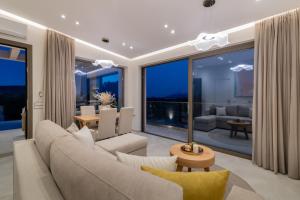a living room with a couch and a table at De Hierro Exclusive Villa - Magical Hospitality in a Villa with Pool and Breathtaking Views By Villa Mana Gers in Plános