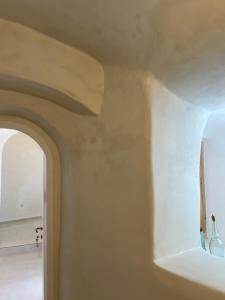 a white wall with a window in a room at Cave Noelia in Fira +69 photos