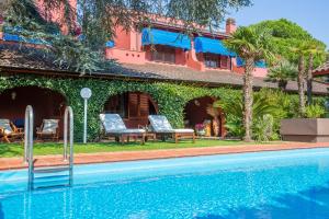 a swimming pool in front of a house at Villa MariSoul - Villa in San Felice Circeo in Borgo Montenero