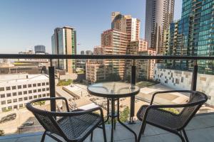 a balcony with a table and chairs and a view of a city at IMSA Group in Melbourne