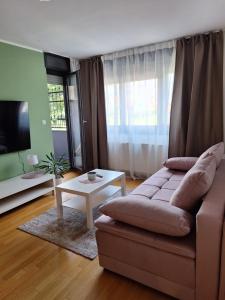 a living room with a couch and a table at Apartman Lory, Zagreb, Downtown, with own parking in the garage in Zagreb