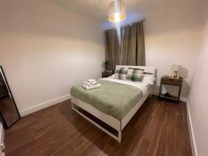 a small bedroom with a bed and a window at Park View Homestay in Barking