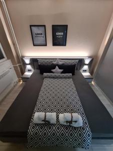 a bed in a room with two pictures on the wall at NOA Luxury Apartment in Bitola