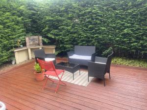 a deck with chairs and a table and a grill at Location, location in Gateshead +5 photos