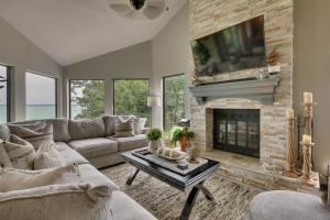 a living room with a couch and a fireplace at Lakehouse Hot Tub, Waterslide, Game Room and Kayaks in Blanchard