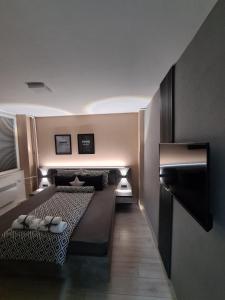 a bedroom with two beds with slippers on them at NOA Luxury Apartment in Bitola