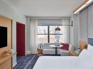 a hotel room with a bed and a living room at 21c Museum Hotel Chicago in Chicago