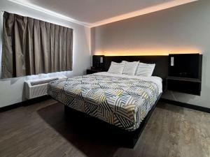 a hotel room with a bed and a window at Studio 6 Ogden, UT 21st Street in Ogden +21 photos