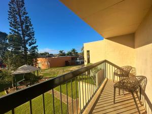 a balcony with two chairs and a gazebo at Riverview Holiday Apartment 53 - Kalbarri WA in Kalbarri