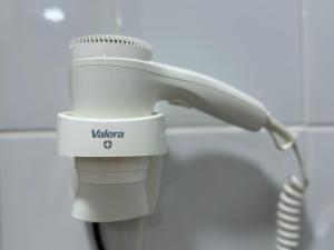 a white hairdryer sitting next to a telephone at Family Surf Chicama in Puerto Chicama