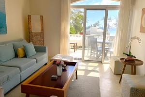 a living room with a couch and a table at Spectacular Penthouse Ocean Views. Playa Bavaro. Punta Cana in Punta Cana
