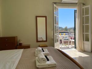 a bedroom with a bed with towels on it at Alexandra's Apartments in Sidari