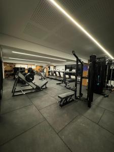 a gym with a row of equipment in a room at Flat Beira-mar - Pepper Village in Salvador