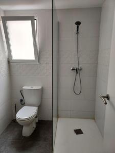 een badkamer met een toilet en een douche met een raam bij dama iberica II in Valencia
