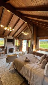 a large bedroom with a large bed and a fireplace at Cabanas Vale Verde in Praia Grande