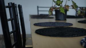 a group of black mats on a counter with plants at Dreams hotel RestoBar in Armenia