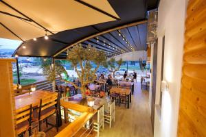 a restaurant with tables and people sitting at tables at Hotel Veliaj in Ksamil