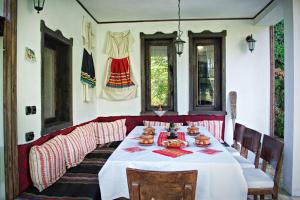 a dining room with a table with food on it at Milkovata Guest House in Koshov