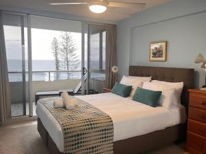 a bedroom with a bed with a view of the ocean at Park Towers Holiday Units in Gold Coast