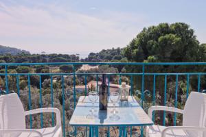 a table with wine glasses on a balcony at Aelia Studios in Koukounaries
