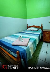 1 dormitorio con 2 camas y paredes azules y verdes en Residencial Guzmán 1 en Yacuíba