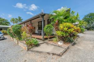 a house with a lot of plants in front of it at Tasman Holiday Parks - Cairns Cool Waters in Cairns