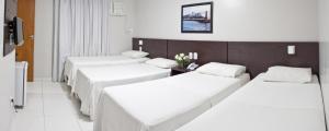 Postel nebo postele na pokoji v ubytování Absolutte Hotel