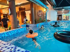 a group of people in a swimming pool at Vangvieng Pool House Hotel in Vang Vieng +43 photos