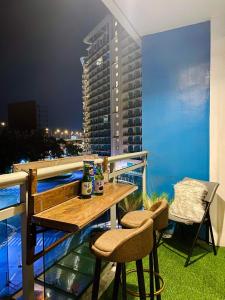 a table and chairs on the balcony of a building at Azure Urban Residences in Manila
