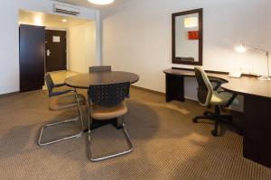 an office with a table and chairs and a mirror at Holiday Inn Express Guadalajara Iteso, an IHG Hotel in Guadalajara