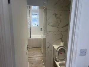 a bathroom with a toilet and a sink at Harrington Apartments in Central London in London