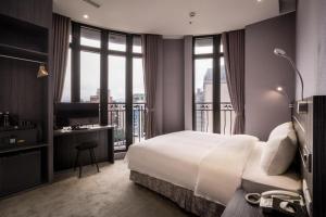 Postel nebo postele na pokoji v ubytování Yi Su Hotel-Taipei Ningxia