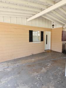an empty garage with a white wall at Necessary Retreat in Orlando