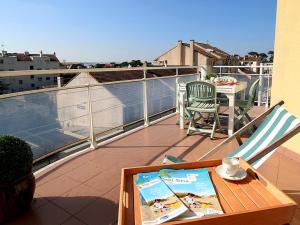 a balcony with a table and chairs on a roof at Appartement Tout Confort entre Plage et Commerces à Saint-Brevin-les-Pins - FR-1-364-55 in Saint-Brevin-les-Pins