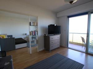 a living room with a bed and a tv and a window at Studio cosy avec balcon à Saint-Brevin, 3 pers. - FR-1-364-137 in Saint-Brevin-les-Pins