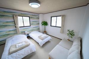 Una cama o camas en una habitación de FUJIクロスゲートハウス