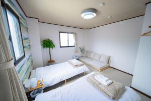 Una cama o camas en una habitación de FUJIクロスゲートハウス