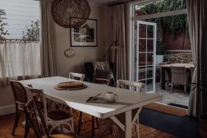 a living room with a white table and chairs at Little Talisker in Stanley