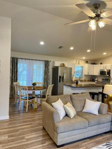 a living room with a couch and a kitchen at Cozy 3 Bedroom Vacation Home in North Port
