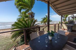 a table on a balcony with a view of the beach at Tasman Holiday Parks - Rollingstone in Rollingstone +79 photos