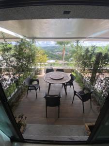 a view of a patio with a table and chairs at Apt Alto da Serra Villas - Bananeiras in Bananeiras