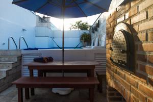 una mesa de picnic con una sombrilla en el patio en 3BDR Duplex Penthouse Ipanema Private Pool with marvelous views, en Río de Janeiro