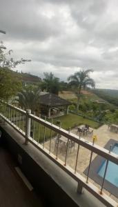 a balcony with a view of a park and a pool at Apt Alto da Serra Villas - Bananeiras in Bananeiras