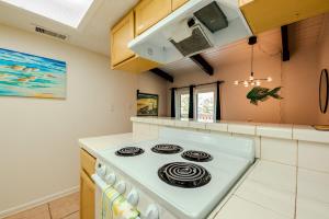 a kitchen with a white stove top oven at Seagulls Serenade Cozy 1BR Hideaway near Beach 206 in South Padre Island