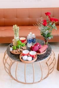 a coffee table with a tray of food on it at ALEX HOTEL and SPA in An Bàn (2)