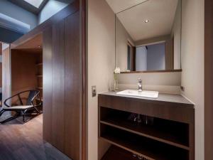 a bathroom with a sink and a mirror at Kotohi Machiya House in Kyoto +51 photos