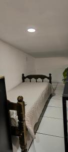 a bedroom with a bed in a white room at Apartamento Confort Loft 01 in Ponta Porã
