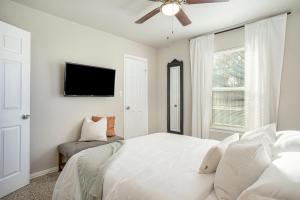 a white bedroom with a bed and a ceiling fan at The Southern Sapphire - A Cozy Lake View Getaway in Granbury