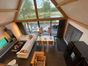 an overhead view of a living room with a large window at Luxury holiday Thatched House In Baarle-Nassau in Baarle-Nassau