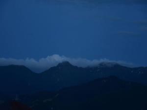 a view of a mountain range with clouds in the sky at KKR Yuzawa Yukiguni in Yuzawa